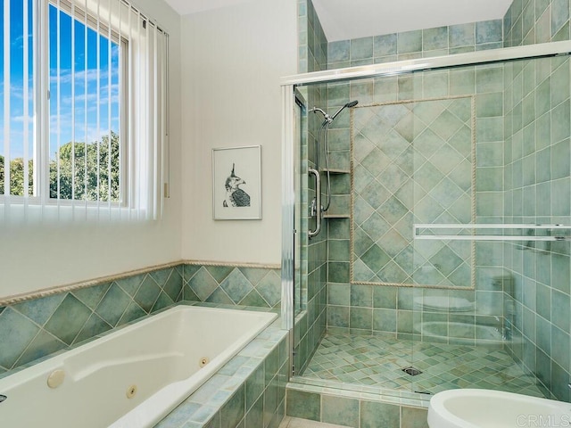 bathroom featuring a jetted tub and a stall shower