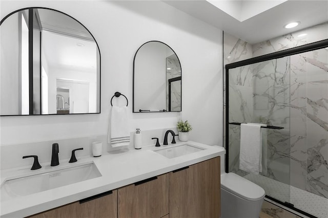 bathroom featuring vanity, toilet, and walk in shower