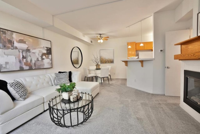 carpeted living room featuring ceiling fan