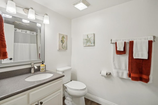 bathroom featuring hardwood / wood-style flooring, vanity, and toilet