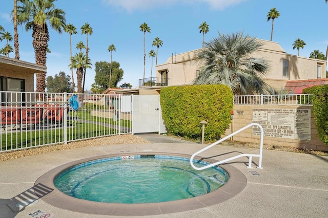 view of swimming pool with a community hot tub