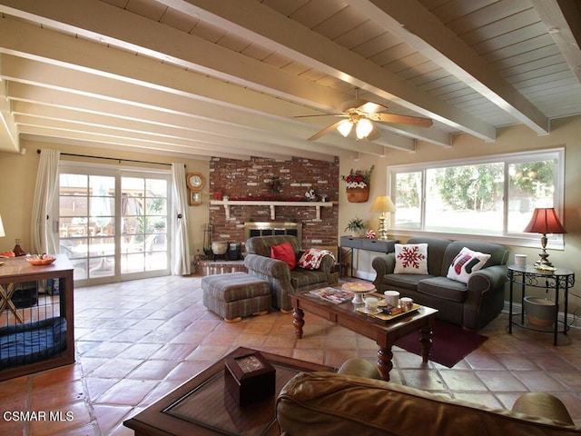 living room with beam ceiling, ceiling fan, and a brick fireplace