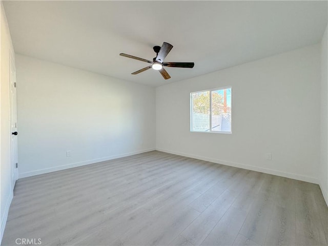 spare room featuring light wood-type flooring and ceiling fan