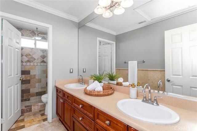 bathroom with vanity, a shower, toilet, ornamental molding, and tile walls