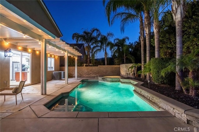 pool at night featuring a pergola, central AC, a jacuzzi, and a patio area