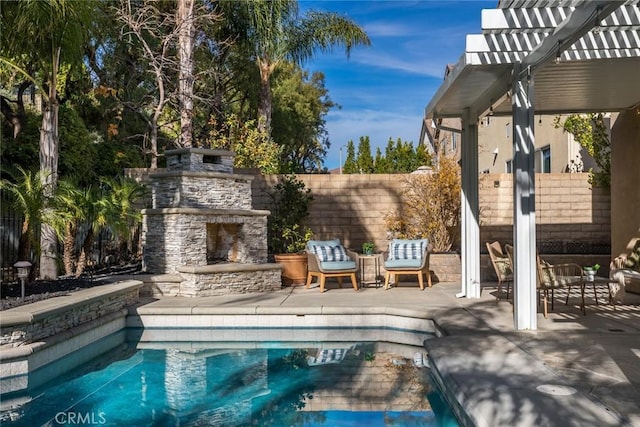 view of pool featuring an outdoor stone fireplace and a patio area