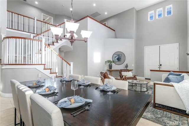 dining area with light tile patterned floors and a high ceiling