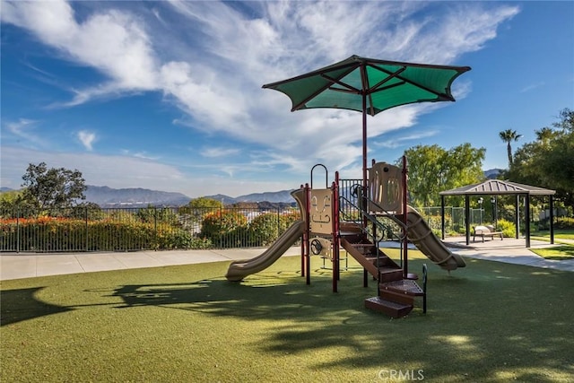 view of jungle gym featuring a mountain view