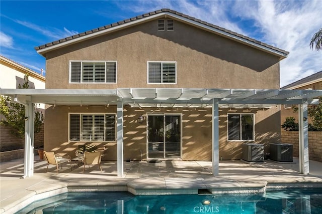 back of house featuring cooling unit, a pergola, and a patio