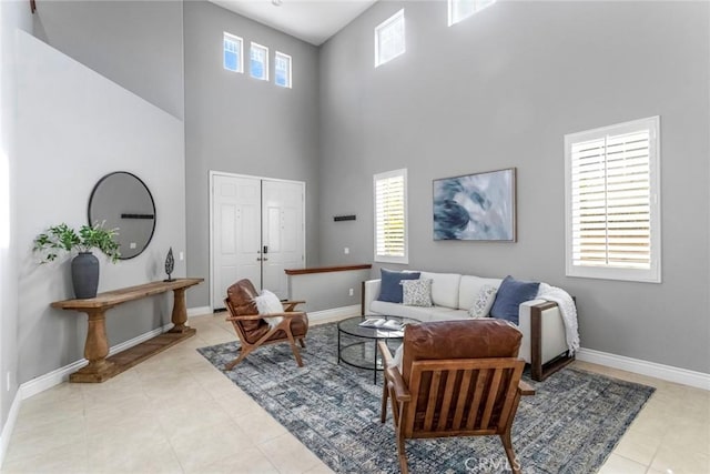 living room with light tile patterned floors and a towering ceiling