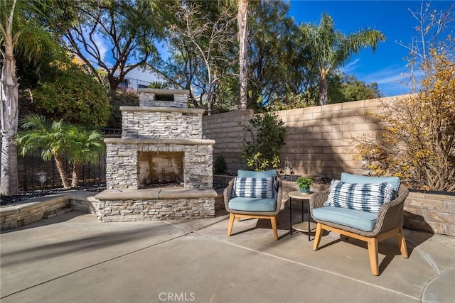 view of patio featuring an outdoor stone fireplace