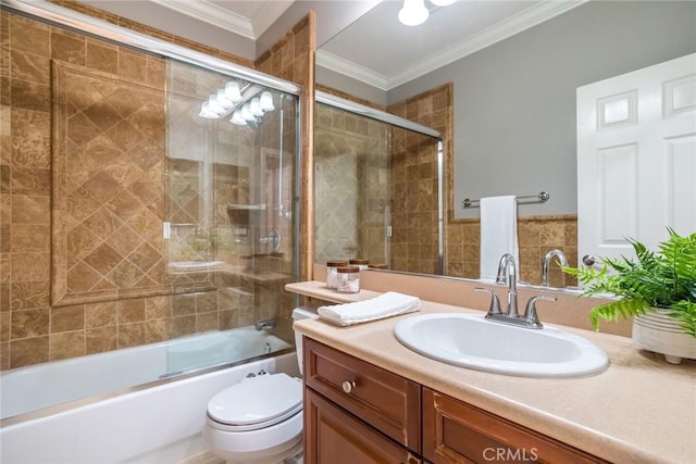 full bathroom featuring vanity, shower / bath combination with glass door, toilet, and ornamental molding