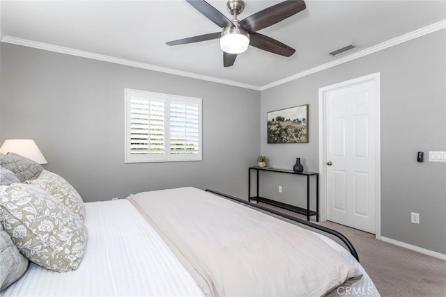 carpeted bedroom with ceiling fan and crown molding