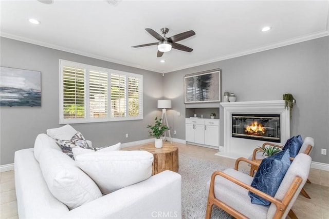 tiled living room featuring ceiling fan and ornamental molding