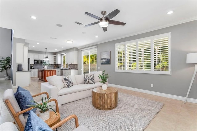 tiled living room featuring ceiling fan and ornamental molding