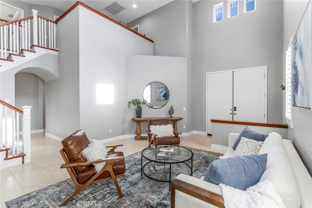 tiled living room with a towering ceiling