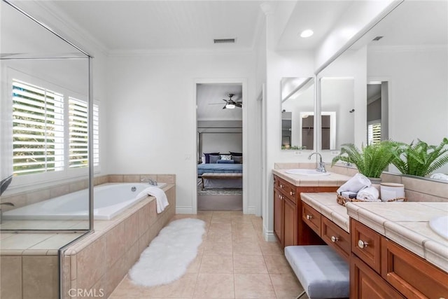 bathroom featuring tile patterned floors, tiled tub, vanity, and ornamental molding