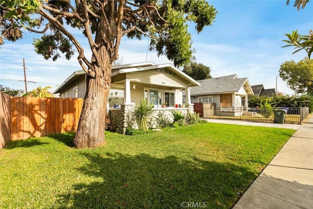 craftsman inspired home with covered porch and a front yard