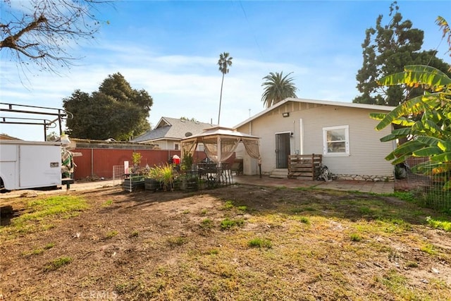 back of house featuring a gazebo, a patio area, and a shed