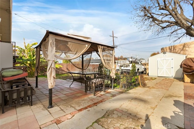 view of patio with a gazebo and a storage shed