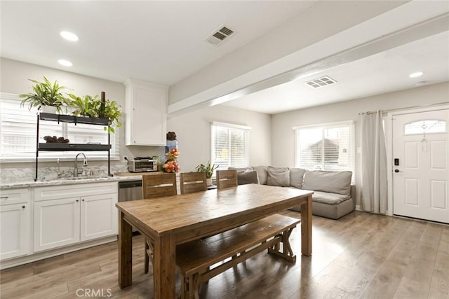 dining space with sink and light hardwood / wood-style flooring