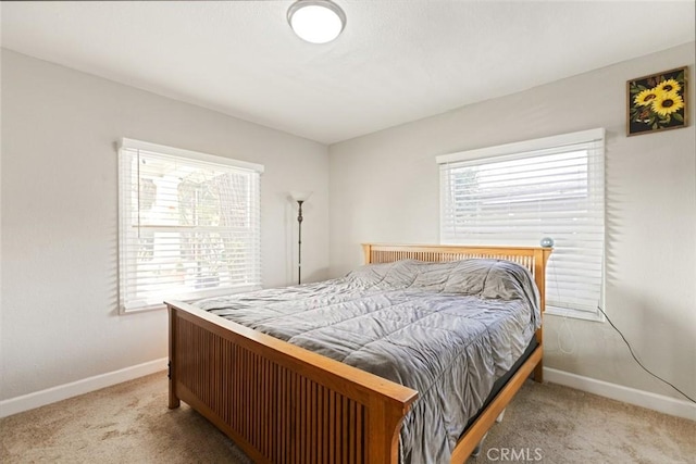 bedroom with multiple windows and carpet