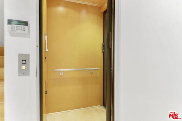 interior details with elevator and wood-type flooring