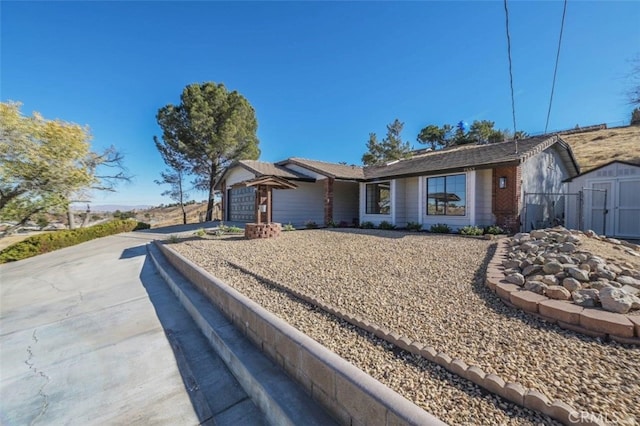 ranch-style house with a shed and a garage