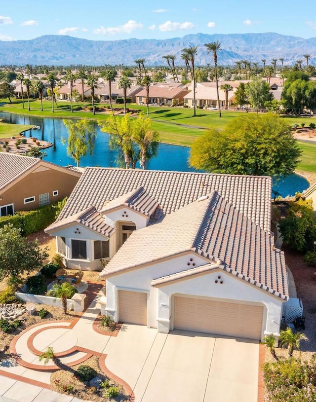 birds eye view of property featuring a water and mountain view