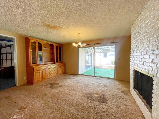 unfurnished living room with a textured ceiling, light colored carpet, and a fireplace