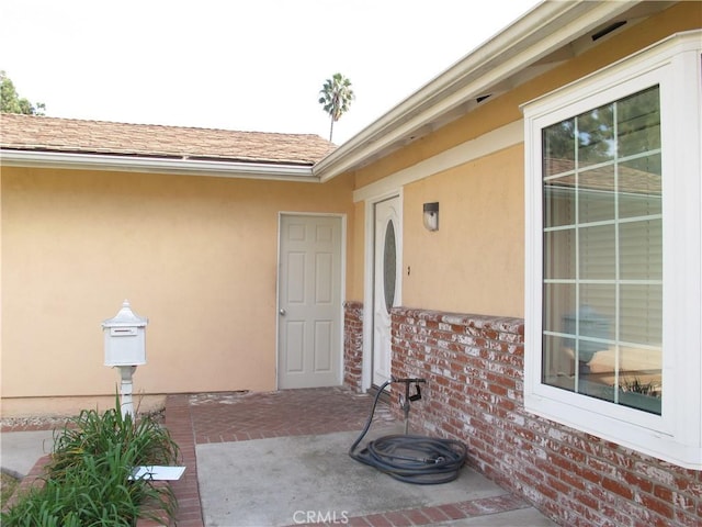 doorway to property with a patio