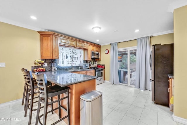 kitchen with kitchen peninsula, tasteful backsplash, ornamental molding, dark stone counters, and stainless steel appliances