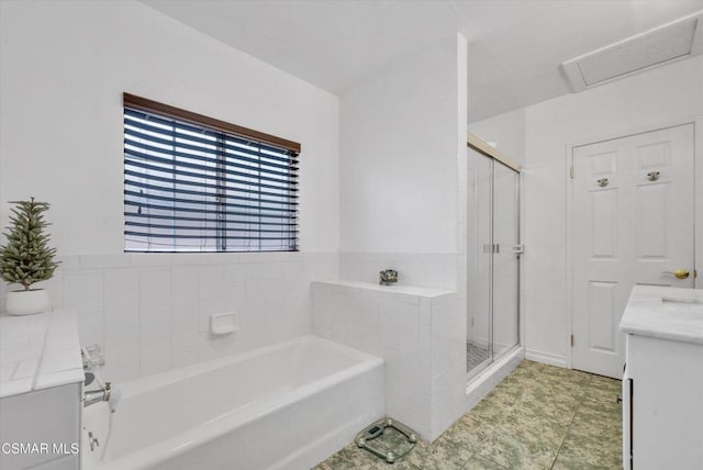 bathroom with tile patterned floors, vanity, and shower with separate bathtub