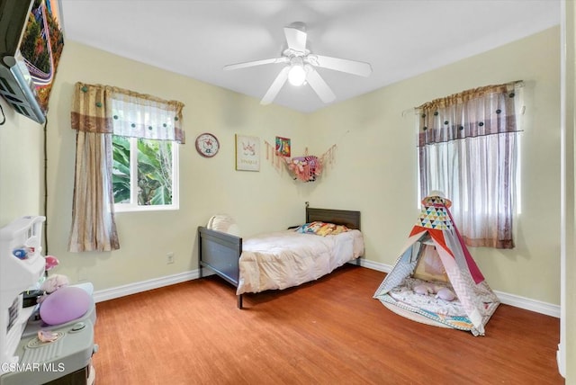 bedroom with hardwood / wood-style floors and ceiling fan