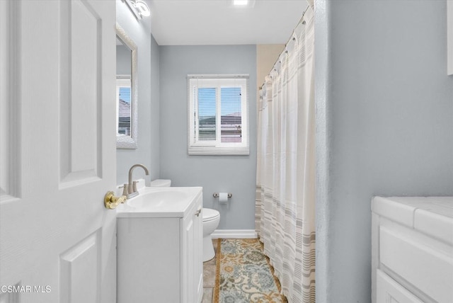 bathroom featuring tile patterned floors, vanity, and toilet