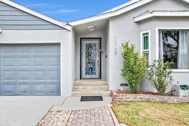 doorway to property with a garage