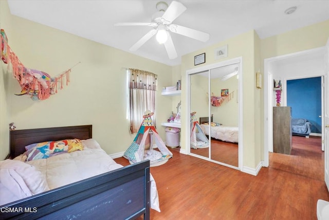 bedroom with hardwood / wood-style floors, ceiling fan, and a closet