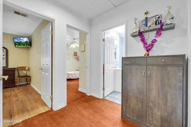 corridor with hardwood / wood-style flooring