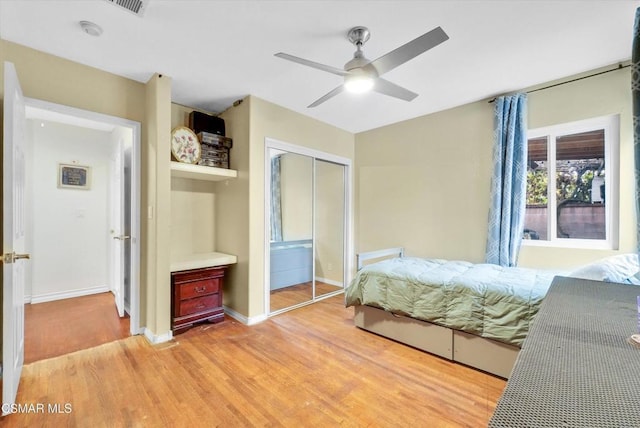 bedroom featuring ceiling fan, a closet, and light hardwood / wood-style flooring