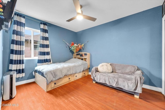 bedroom with wood-type flooring and ceiling fan