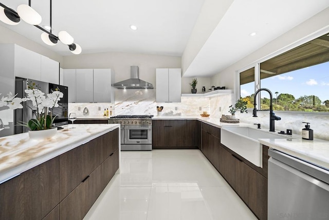 kitchen with white cabinetry, sink, wall chimney exhaust hood, and appliances with stainless steel finishes