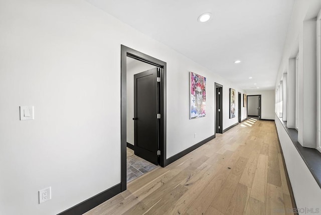 hallway with light hardwood / wood-style flooring