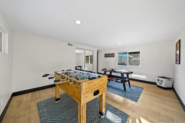 recreation room with light hardwood / wood-style floors