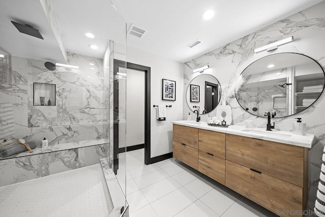 bathroom featuring vanity, tile walls, and a tile shower