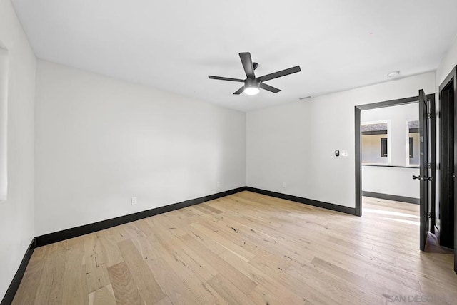 empty room featuring ceiling fan and light hardwood / wood-style floors