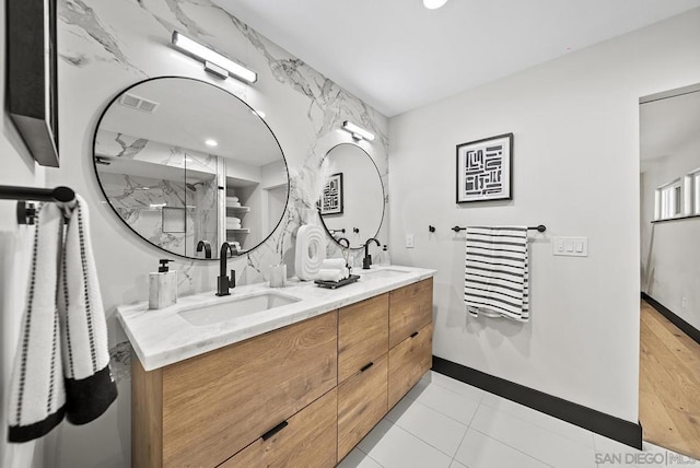 bathroom featuring tile patterned flooring, vanity, and walk in shower