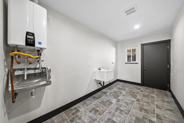 interior space with sink and water heater