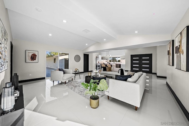 living room featuring lofted ceiling with beams and light tile patterned floors