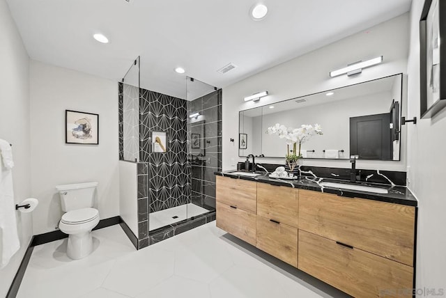 bathroom with tile patterned flooring, walk in shower, vanity, and toilet