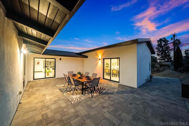 view of patio terrace at dusk